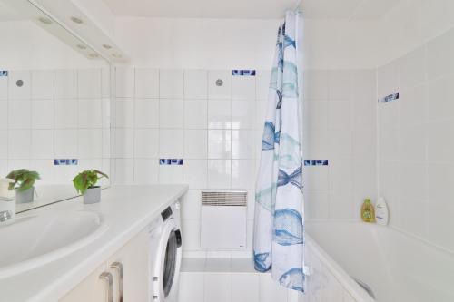 une salle de bain blanche avec un lavabo et une douche dans l'établissement Appartement Quartier Chatelet Les Halles 2 Free Netflix, à Paris