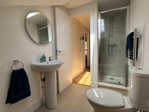 a bathroom with a toilet and a sink and a shower at New! Central Penthouse, King Size Bed & Balconies in Maidstone