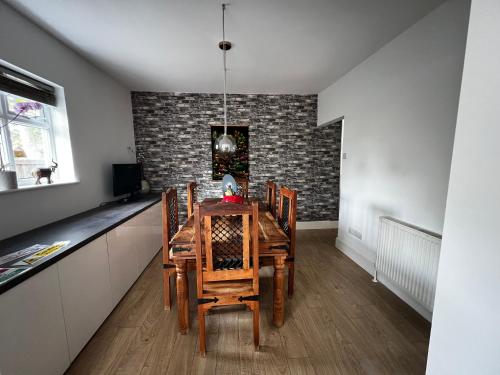 a dining room with a wooden table and chairs at Cozyleigh in Southend-on-Sea