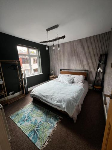 a bedroom with a large bed and a rug at Cozyleigh in Southend-on-Sea