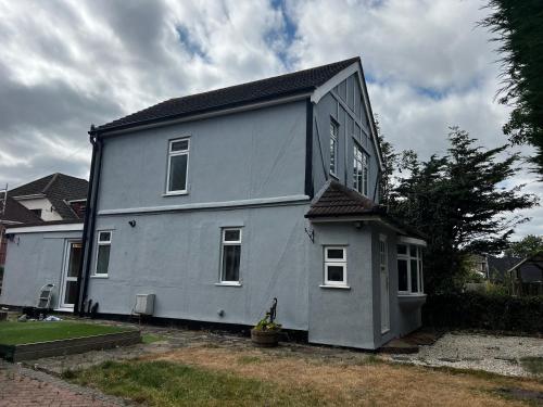 a gray house with a black roof at Cozyleigh in Southend-on-Sea