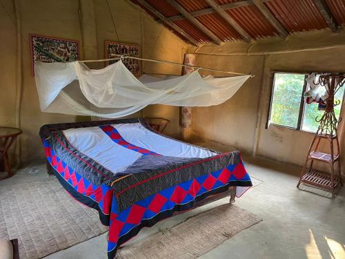 Bett in einem Zimmer in einem Zelt in der Unterkunft Bardia dolphin home in Bhurkīā
