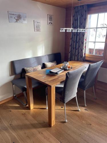 a dining room table and chairs with a wooden table at Chalet La Montanara in Bettmeralp
