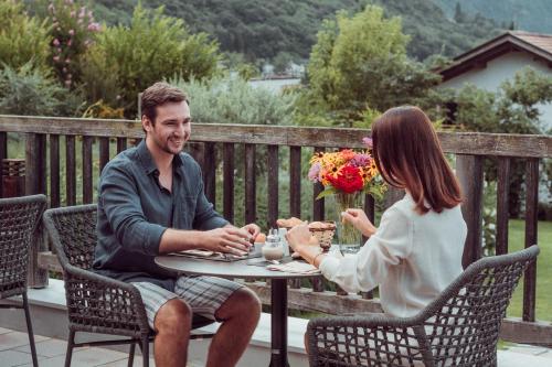a man and a woman sitting at a table at Biohotel theiner's garten in Lana