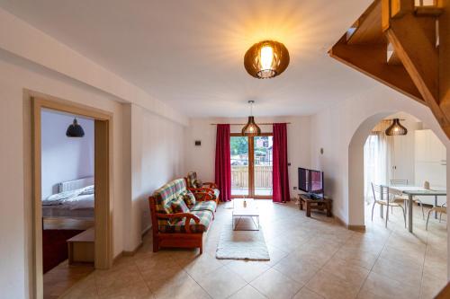 a living room with a couch and a bed at Casa Simona Bran in Bran