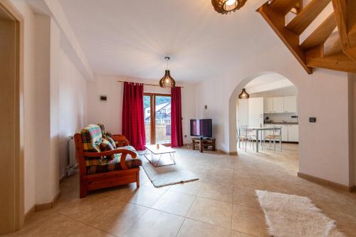a living room with a couch and a chair at Casa Simona Bran in Bran