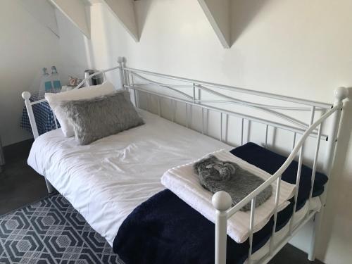 a bedroom with a bunk bed with a metal frame at La Maison Bleue, luxury self-catering villa. in Langebaan
