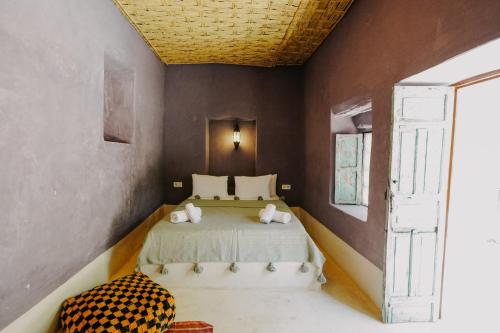 a bedroom with a bed in a room at Hotel & Spa La Ferme El Dar in Marrakech