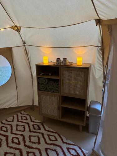 a room with a small table in a tent at The Lily Pad Off Grid in Kingham