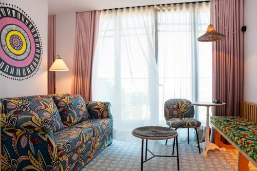 a living room with a couch and a chair at Mama Shelter Lisboa in Lisbon