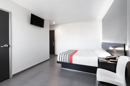 Postel nebo postele na pokoji v ubytování City Express Junior by Marriott Aguascalientes Centro
