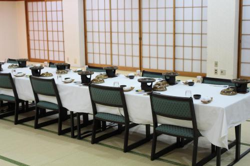 a long table with chairs and food on top of it at Miyajima Seaside Hotel in Miyajima