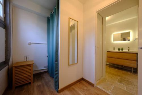a hallway with a bathroom with a sink and a mirror at Sunny and Chill - les canaux de Pont-Audemer in Pont-Audemer