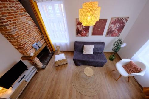 an overhead view of a living room with a couch and chair at Sunny and Chill - les canaux de Pont-Audemer in Pont-Audemer