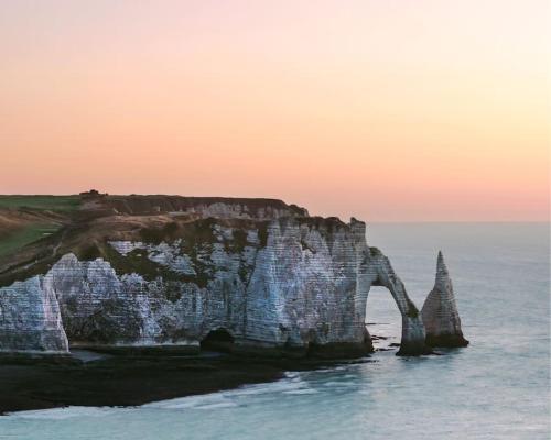a rock formation in the ocean at sunset at Sunny and Chill - les canaux de Pont-Audemer in Pont-Audemer