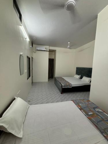 a large room with a bed and a bed at Pipewalas house in Varanasi