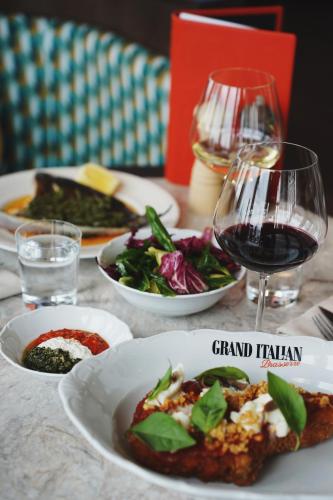 a table with plates of food and a glass of wine at Clarion Hotel Malmö Live in Malmö