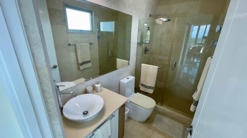 a bathroom with a sink and a toilet and a shower at Apartment with Spectacular Ocean Jungle Views in Playa Bonita Village