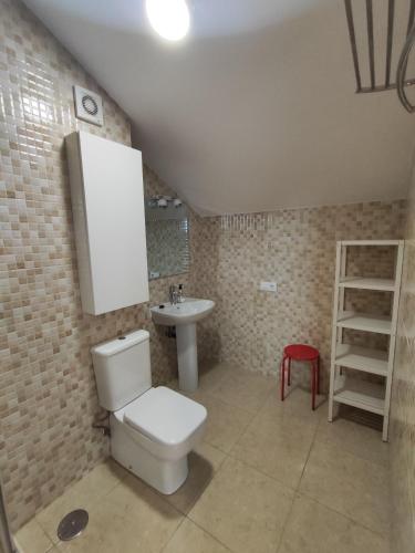 a bathroom with a toilet and a sink at Altos de la Hayuela, a 7 min de Comillas in Comillas