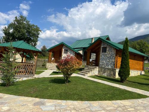 a log cabin with a green roof at Ethno House Bektesevic in Gusinje