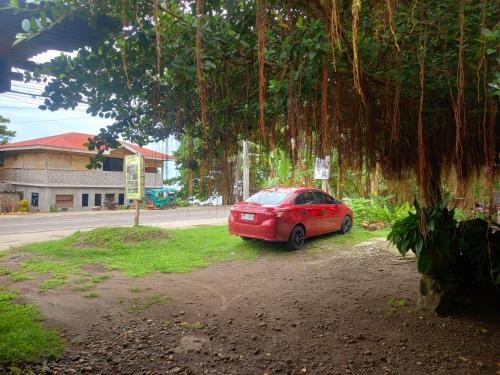 a red car parked on the side of a road at Hidden Tourist Inn in Abu