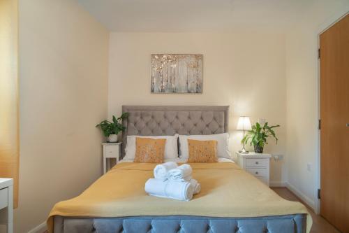 a bedroom with a bed with two towels on it at Steps away from New Street Station & 2 Beds & 2 Baths Flat at City Center in Birmingham