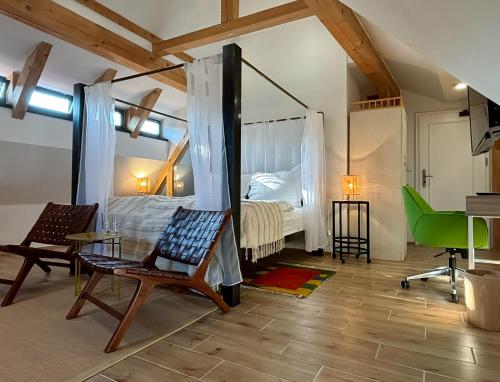 a bedroom with a bed and a table and chairs at Boutique hotel Barvirna in Český Krumlov