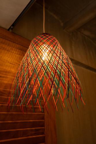a red and green umbrella hanging from a ceiling at The Circle Hostel, La Union in San Fernando