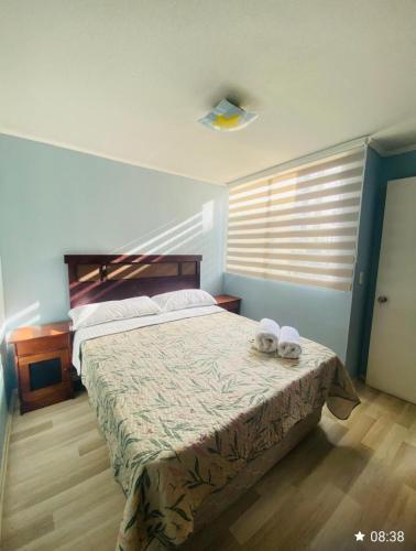 a bedroom with a bed with two towels on it at Departamento céntrico los andes chile in Los Andes