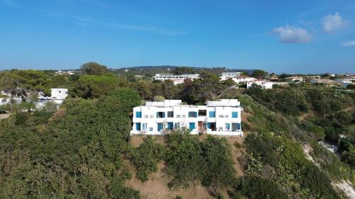 an aerial view of a white house on a hill at Residenza Gherly in Capo Vaticano