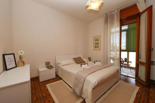 Una habitación blanca con una cama y una ventana en Modena - vicino al centro - Free Parking & Wi-Fi, en Módena