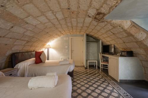 Postel nebo postele na pokoji v ubytování Palazzo Arco Cadura Hotel & Spa