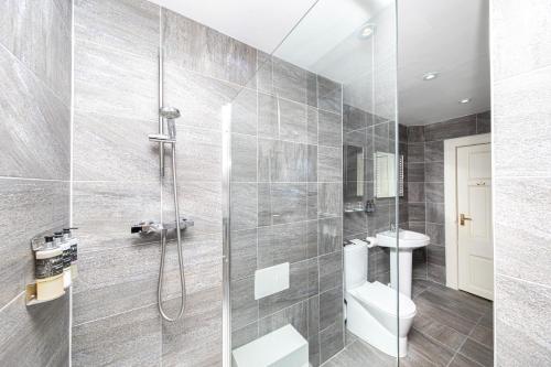 a bathroom with a shower and a toilet at The Atholl Palace in Pitlochry