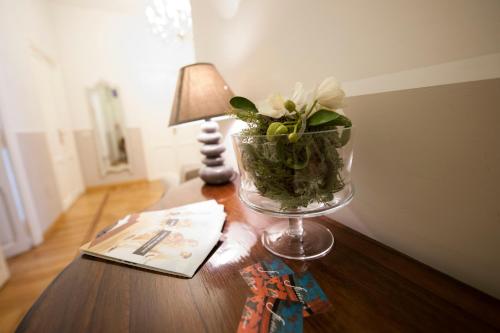
a vase filled with flowers on top of a wooden table at Florian Rooms Guest House in Rome
