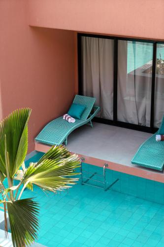 a balcony with two chairs and a laptop on it at Arrey Boutique Hotel in Barra Grande