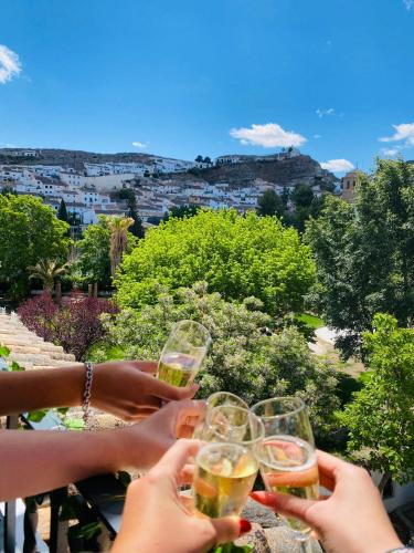 a group of people holding up glasses of wine at Hotel Galera in Galera