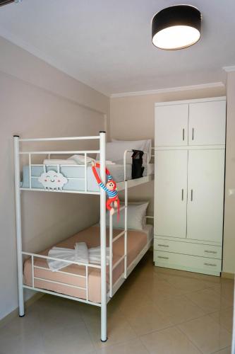 a bedroom with two bunk beds and a white cabinet at Villa Anastasia 2 in Fourka