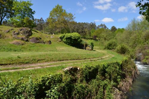 a path leading down a hill next to a river at Rilhadas Casas de Campo in Fafe