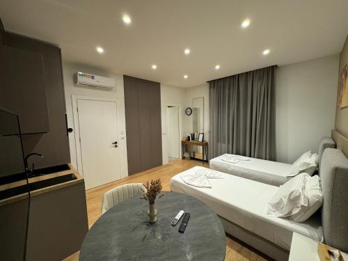 a room with two beds and a table with a couch at Brianza Home in Giussano