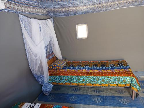 a bedroom with a bed in a room at "Par 4 Chemins" - Atypical stopover in Nouakchott