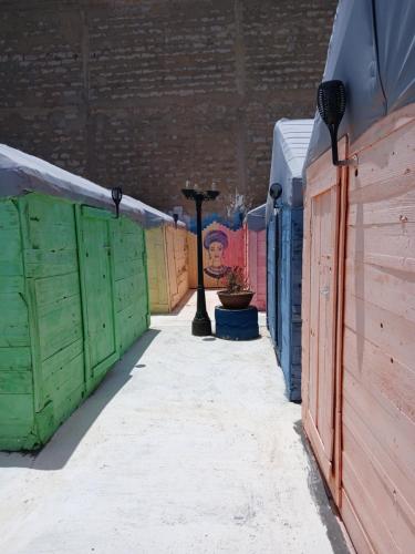 a row of colored stalls in a alley at "Par 4 Chemins" - Atypical stopover in Nouakchott