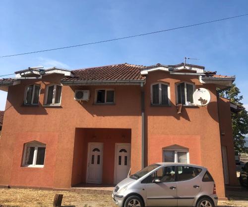 a small silver car parked in front of a house at Romana in Golubac