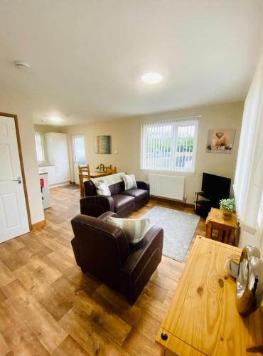 a living room with a couch and a table at Tulip Cabin with Hot Tub in York