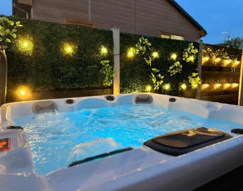 a jacuzzi tub in a backyard at night at Tulip Cabin with Hot Tub in York