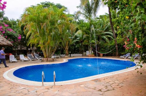 a swimming pool in the middle of a resort at Langi Langi Beach Bungalows in Nungwi