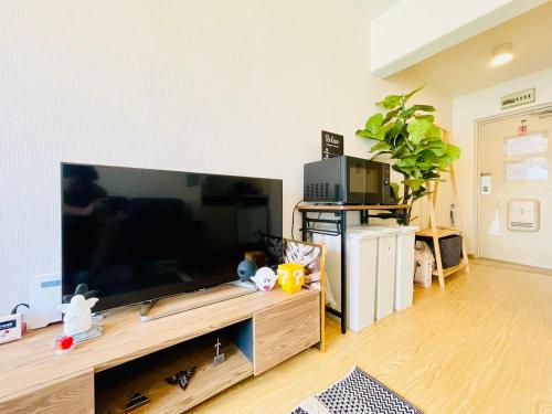 a living room with a large flat screen tv at Alo BnB 12 - Game Universe - Easy Access to Shibuya - New ! in Tokyo