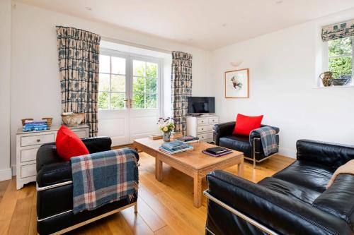 a living room with two couches and a coffee table at Finest Retreats - Coach House Wellbeing Retreat in Pen y Clawdd