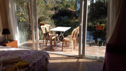 a bedroom with a balcony with a table and chairs at Rose Apart in Sarigerme