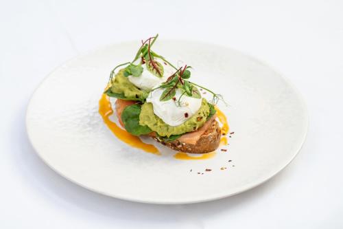 a white plate with a dish on a white table at Stanbrook Abbey Hotel, Worcester in Worcester