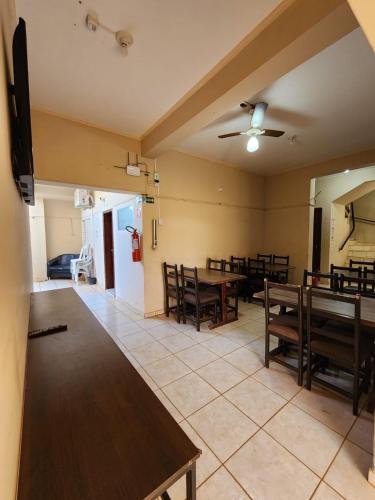 a dining room with wooden tables and chairs at Économique Hotel in Ilha Solteira
